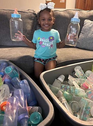 Photo courtesy Faith Maternity Care
FMC Residential Assistant Symone Kuschel's three-year-old daughter Emira displays some of the baby bottles for our upcoming Baby Bottle Fundraiser.